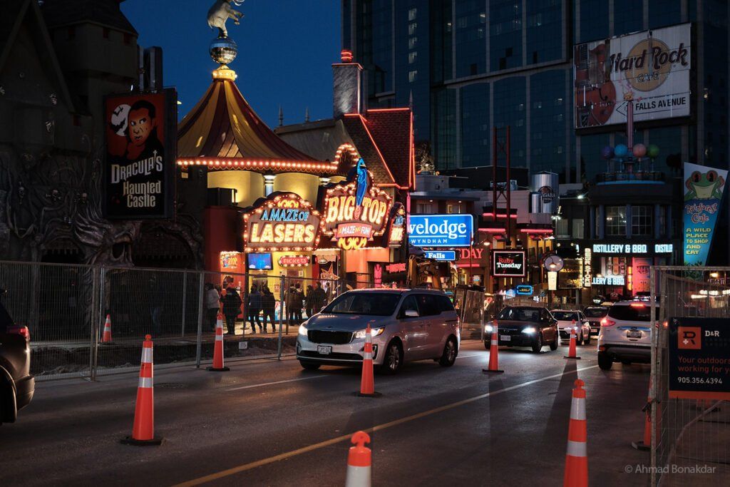 Neon signs and traffic cones on a Niagara street at night
